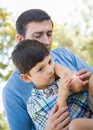 Loving Father Puts a Bandage on the Elbow of His Young Son