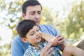 Loving Father Puts a Bandage on the Elbow of His Young Son