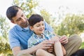 Loving Father Puts a Bandage on the Elbow of His Young Son in th