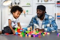 Loving Father Teaches and Plays with Little Son at Home for Skill Development with Wooden Toy and Color Cube. Father Nurtures