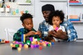 Loving Father Teaches and Plays with Son at Home for Learning and Education on Counting Cube in Math and Skill Development. Father