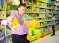 Father choosing playthings in toy store