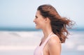 Loving the fresh breeze. an attractive woman enjoying a day at the beach.