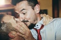 Loving gay couple kissing passionately at the wedding party - Two handsome men having romantic kiss indoors - LGBT wedding and Royalty Free Stock Photo