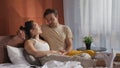Loving gay couple relaxing in bed in morning and chatting Royalty Free Stock Photo