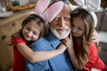 Loving girls hugging their grandpa stock photo