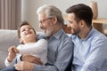 Three generations of men have fun relaxing together Royalty Free Stock Photo