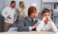 Grandmother comforting grandson while parents quarreling Royalty Free Stock Photo