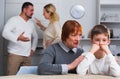 Grandmother comforting grandson while parents quarreling Royalty Free Stock Photo