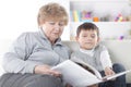 Loving grandmother reads a book to her grandson.photo with copy space