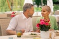 Loving grey-haired mature man looking at his beautiful wife