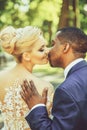 Loving groom touches shoulder of adorable bride