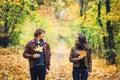 Loving happy couple in autumn in park holding autumn maple leaves in hands. Royalty Free Stock Photo