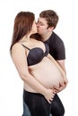 Loving happy couple, husband kissing pregnant woman Royalty Free Stock Photo