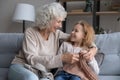 Loving senior grandmother and small granddaughter knit together Royalty Free Stock Photo