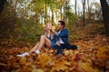 Loving happy young couple in forest park in autumn on nature at sunset background Royalty Free Stock Photo
