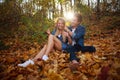 Loving happy young couple in forest park in autumn on nature at sunset background Royalty Free Stock Photo