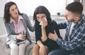 Loving husband calming his crying wife at psychotherapy session Royalty Free Stock Photo