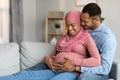 Loving Husband Hugging Pregnant Muslim Wife While Relaxing On Couch At Home Royalty Free Stock Photo