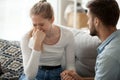 Loving husband man comforting consoling upset crying wife woman