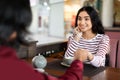 Loving indian couple chatting in coffee shop at lunchtime Royalty Free Stock Photo