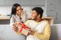 Loving indian wife surprising her husband with gift at home