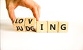 Loving or judging symbol. Concept words Loving or Judging on wooden cubes. Businessman hand. Beautiful white table white