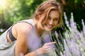 Loving lavender. A young woman smelling lavender in her garden. Royalty Free Stock Photo