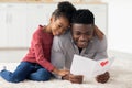 Loving little black girl greeting her dad with Fathers Day Royalty Free Stock Photo