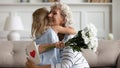 Loving little girl greeting grandmother with anniversary Royalty Free Stock Photo