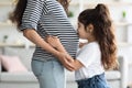 Loving little girl kissing her pregnant mother big belly Royalty Free Stock Photo