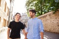 Loving Male Gay Couple On Vacation Holding Hands Walking Along City Street Royalty Free Stock Photo