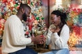 Loving man making proposal to his excited girlfriend, giving engagement ring