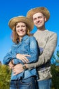 Loving man and woman embracing outside on sky background