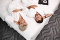 Loving married couple lie on bed in hotel, relax Royalty Free Stock Photo