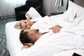 Loving married couple lie on bed in hotel, relax Royalty Free Stock Photo