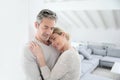 Loving mature couple embracing at home