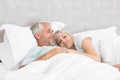 Loving mature man and woman lying in bed Royalty Free Stock Photo