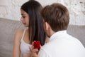 Loving man doing proposal to young woman rejecting offer