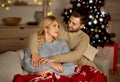 Loving man and woman bonding at home on xmas eve Royalty Free Stock Photo