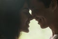Loving man and woman getting closer to kiss each other