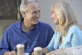 Loving Middle Aged Couple Sitting At CafÃÂ©