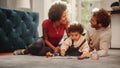 Loving Mixed Race Family Playing with Toys with Adorable Baby Boy at Home on Living Room Floor. Ch Royalty Free Stock Photo