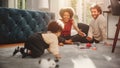 Loving Mixed Race Family Playing with Toys with Adorable Baby Boy at Home on Living Room Floor. Ch Royalty Free Stock Photo