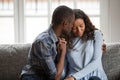 Loving black couple hug on couch making peace after fight Royalty Free Stock Photo