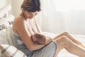 Loving mom breastfeeding her newborn baby at home Royalty Free Stock Photo