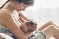 Loving mom breastfeeding her newborn baby at home Royalty Free Stock Photo