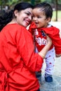 Loving mom carrying of her baby at society park. Bright portrait of happy mum holding child in her hands. Mother hugging her Royalty Free Stock Photo