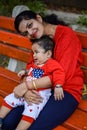 Loving mom carrying of her baby at society park. Bright portrait of happy mum holding child in her hands. Mother hugging her Royalty Free Stock Photo