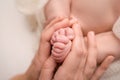 Loving mom hold baby& x27;s legs. Happy childhood. Parental care. Concept of a happy family. Royalty Free Stock Photo